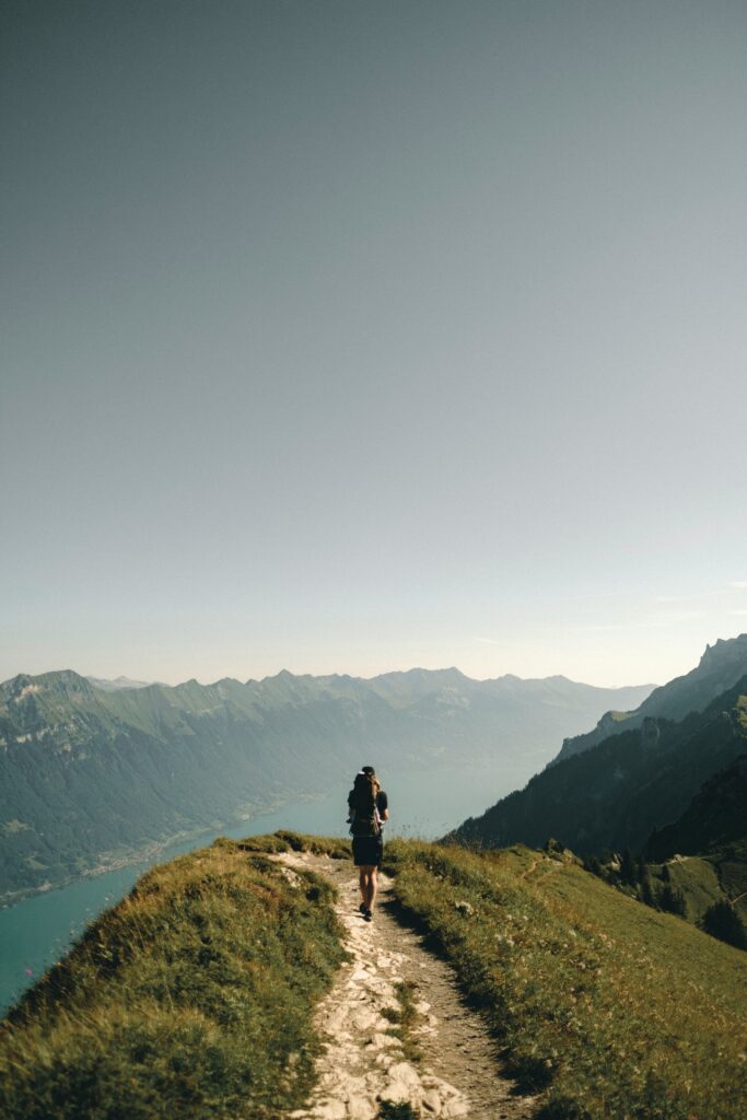 A hiker on a mountain ridge taking in the beautiful views around him.